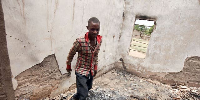 The choir master Patrick Onmepe walks among debris of the burnt building of St. Peter Catholic Church following attacks by Fulani herdsmen at Agatu community in Benue State, north-central Nigeria, on May 10, 2016. (AFP/EMMANUEL AREWA)