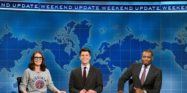 Tina Fey, Colin Jost and Michael Che sit at the "Weekend Update" desk on "Saturday Night Live," Aug. 17, 2017.