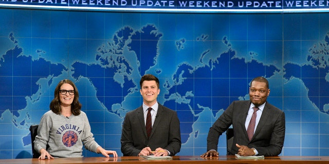 Tina Fey, Colin Jost and Michael Che sit at the "Weekend Update" desk on "Saturday Night Live," Aug. 17, 2017.