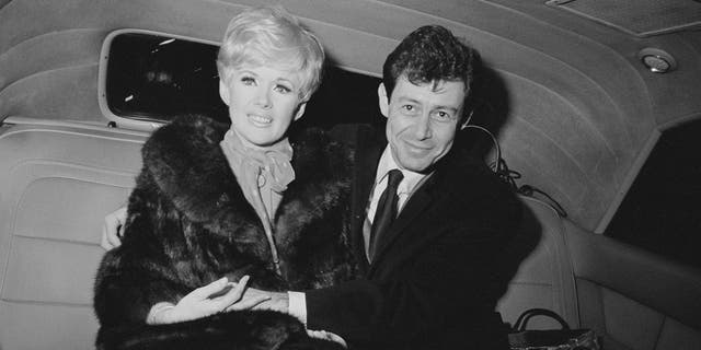 American singer and actor Eddie Fisher (1928 - 2010) with his fiancée, American actress, singer and producer Connie Stevens, sitting in the back of a car after announcing their engagement circa 1967.