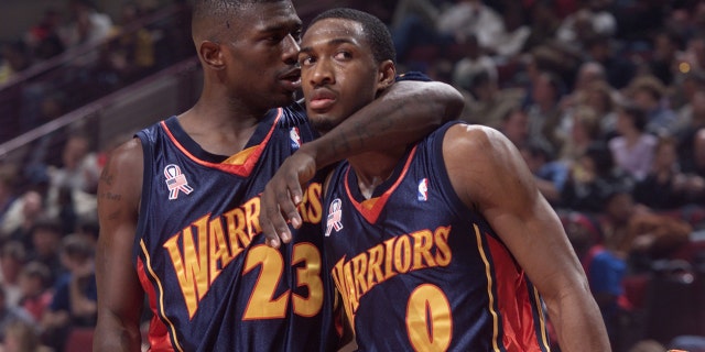 23 Feb 2002: Jason Richardson #23 of the Golden State Warriors takes new teammate Gilbert Arenas under his wing during a game against the Chicago Bulls at the United Center in Chicago, Illinois.