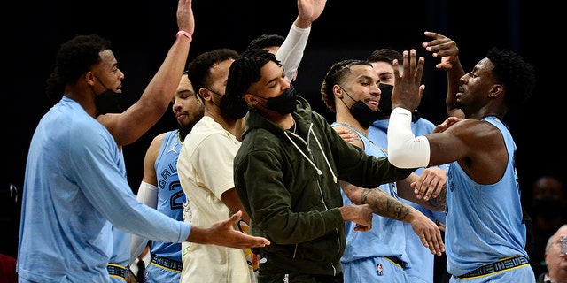 Memphis Grizzlies forward Jaren Jackson Jr., right, greets teammates in the first half of an NBA basketball game against the Oklahoma City Thunder, Thursday, Dec. 2, 2021, in Memphis, Tenn.