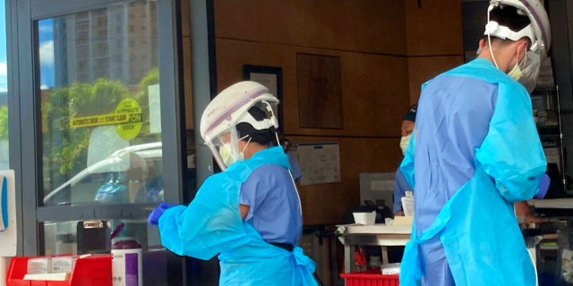 Hospital workers process COVID-19 tests at a hospital in Aiea, Hawaii, Wednesday, Sept. 15, 2021.