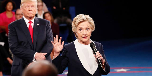 ST LOUIS, MO - OCTOBER 09:  Democratic presidential nominee former Secretary of State Hillary Clinton (R) speaks as Republican presidential nominee Donald Trump listens during the town hall debate at Washington University on October 9, 2016 in St Louis, Missouri. This is the second of three presidential debates scheduled prior to the November 8th election.  (Photo by Rick Wilking-Pool/Getty Images)