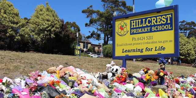 Flowers and tributes are seen outside Hillcrest Primary School in Devonport, Tasmania, Australia December 17, 2021. Australian police on Friday said investigations were continuing into the deaths of five children after a jumping castle was lifted into the air from strong winds at the school’s end-of-year celebration, including if it was properly tied to the ground. AAP Image/Ethan James via REUTERS ATTENTION EDITORS - THIS IMAGE WAS PROVIDED BY A THIRD PARTY. NO RESALES. NO ARCHIVE. AUSTRALIA OUT. NEW ZEALAND OUT
