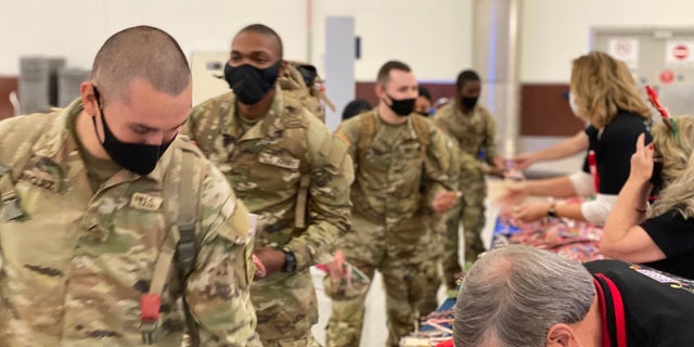 Soldiers heading home for the holidays are greeted at the Atlanta airport with goodies before they board their planes. 