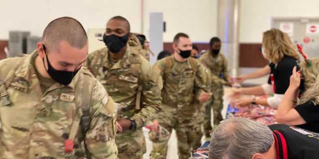Soldiers heading home for the holidays are greeted at the Atlanta airport with goodies before they board their planes.