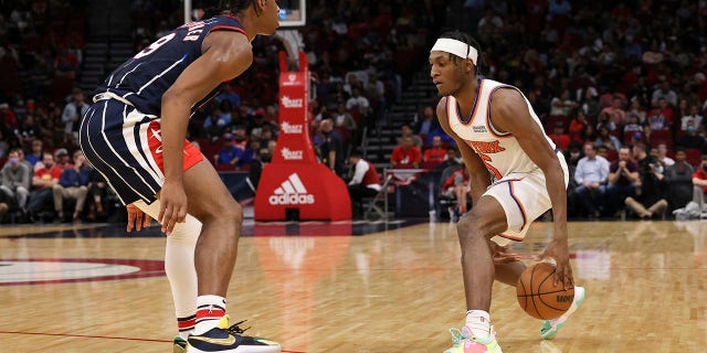 Dec 16, 2021; Houston, Texas, USA; New York Knicks guard Immanuel Quickley (5) dribbles against Houston Rockets guard Josh Christopher (9) in the third quarter at Toyota Center.