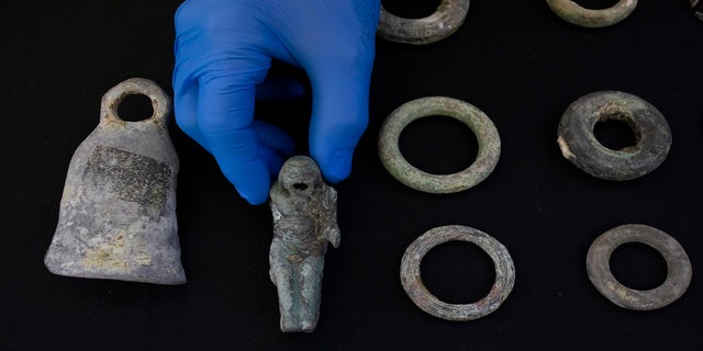 Jacob Sharvit, director of the Marine Archaeology Unit of the Israel Antiquities Authority, holds the finds made near the ancient city of Caesarea in Jerusalem on Wednesday 