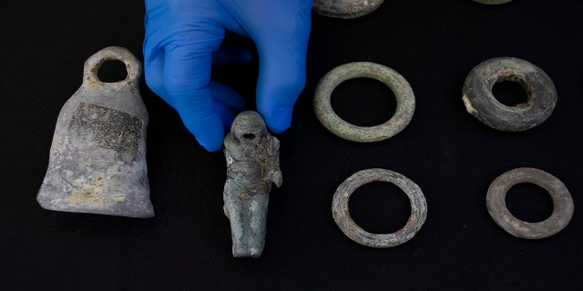 Jacob Sharvit, director of the Marine Archaeology Unit of the Israel Antiquities Authority, holds the finds made near the ancient city of Caesarea in Jerusalem on Wednesday