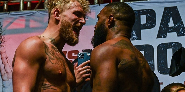 YouTube personality Jake Paul (L) and martial artist Tyron Woodley (R) face off Dec. 17, 2021, during their weigh-in ahead of their fight in Tampa, Fla.