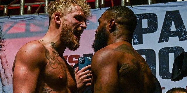 YouTube personality Jake Paul (L) and martial artist Tyron Woodley (R) face off Dec. 17, 2021, during their weigh-in ahead of their fight in Tampa, Fla.