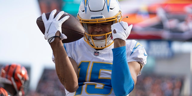 Los Angeles Chargers' Jalen Guyton reacts after a touchdown reception during the first half of an NFL football game against the Cincinnati Bengals, Sunday, Dec. 5, 2021, in Cincinnati.