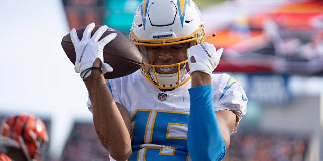 Los Angeles Chargers' Jalen Guyton reacts after a touchdown reception during the first half of an NFL football game against the Cincinnati Bengals, Sunday, Dec. 5, 2021, in Cincinnati.