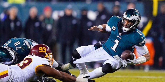 Washington Football Team's Jonathan Allen sacks Eagles quarterback Jalen Hurts Dec. 21, 2021, a Philadelphia.