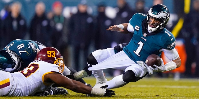 Washington Football Team's Jonathan Allen sacks Eagles quarterback Jalen Hurts Dec. 21, 2021, in Philadelphia.