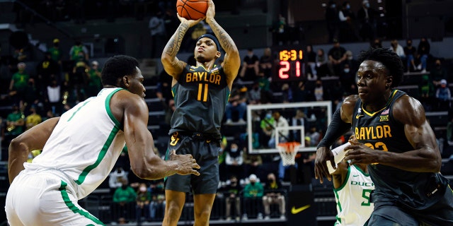 Baylor guard James Akinjo (11) shoots against Oregon during an NCAA college basketball game in Eugene, Ore., Saturday, Dec. 18, 2021.