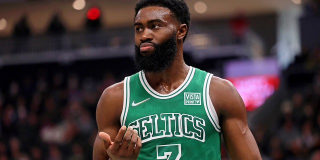 Boston Celtics guard Jaylen Brown (7) reacts after chipping his tooth on a play against the Milwaukee Bucks during the first half of an NBA basketball game Saturday, Dec. 25, 2021, in Milwaukee.