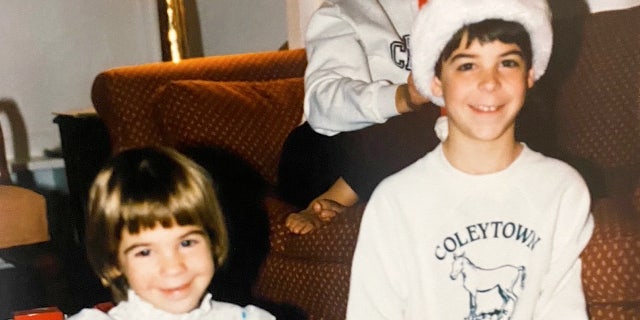 A young Jesse Watters (right) is shown with his sister, Aliza, opening gifts at Christmas. As a child, he remembers going door-to-door to sing Christmas carols for neighbors and friends.