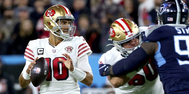 Jimmy Garoppolo (10) of the San Francisco 49ers looks for an open teammate to pass to in the first quarter of a game against the Tennessee Titans at Nissan Stadium Dec. 23, 2021, in Nashville.