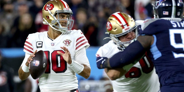 Jimmy Garoppolo (10) of the San Francisco 49ers looks for an open teammate to pass to in the first quarter of a game against the Tennessee Titans at Nissan Stadium Dec. 23, 2021, in Nashville.