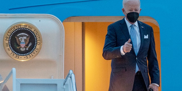 President Biden gestures as he boards Air Force One en route to South Carolina State University on Dec. 17, 2021, at Andrews Air Force Base, Maryland.