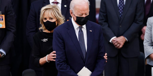 President Joe Biden stands with first lady Jill Biden as they arrive for a congressional ceremony to honor former Sen. Bob Dole, at the U.S. Capitol Rotunda in Washington, Thursday, Dec. 9, 2021. (Jonathan Ernst/Pool via AP)
