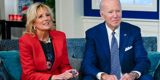 President Biden and first lady Jill Biden speak with the NORAD Tracks Santa Operations Center on Peterson Air Force Base, Colo., via teleconference in the South Court Auditorium on the White House campus in Washington, Friday, Dec. 24, 2021. (AP Photo/Carolyn Kaster)