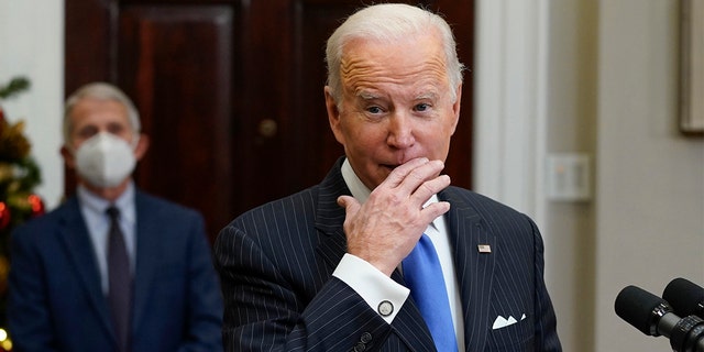 President Biden speaks about the COVID-19 variant named omicron, in the Roosevelt Room of the White House, Monday, Nov. 29, 2021, in Washington. as Dr. Anthony Fauci, director of the National Institute of Allergy and Infectious Diseases listens. 
