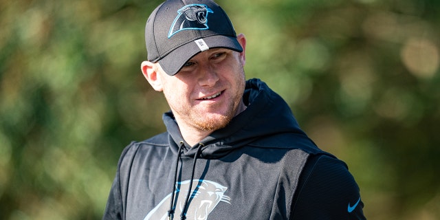 Joe Brady walks onto the field during Panthers' training camp on Aug. 8, 2021, in Spartanburg, South Carolina.