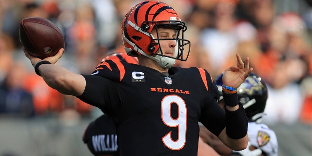 Cincinnati Bengals quarterback Joe Burrow (9) throws during the first half of an NFL football game against the Baltimore Ravens, Sunday, Dec. 26, 2021, in Cincinnati.