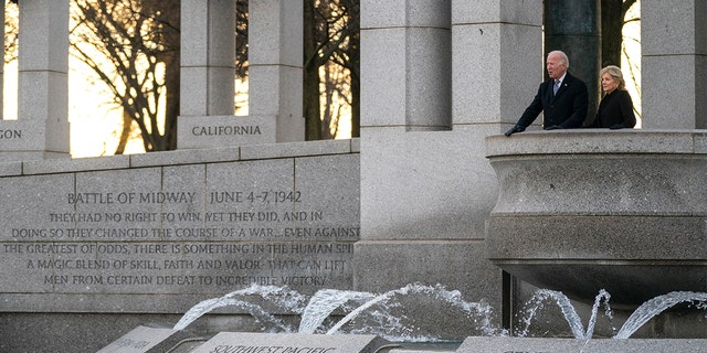 President Biden and first lady Jill Biden visit the National World War II Memorial to mark the 80th anniversary of the Japanese attack on Pearl Harbor, Tuesday, Dec. 7, 2021, in Washington.