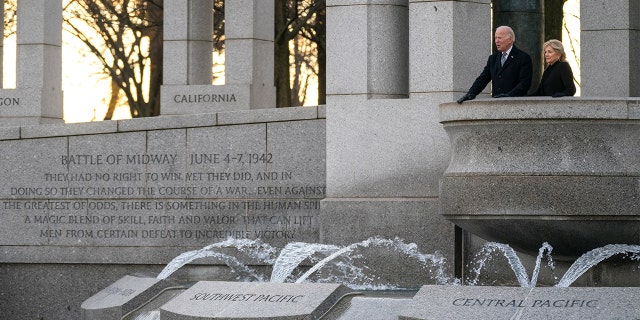 President Biden and first lady Jill Biden visit the National World War II Memorial to mark the 80th anniversary of the Japanese attack on Pearl Harbor, Tuesday, Dec. 7, 2021, in Washington.