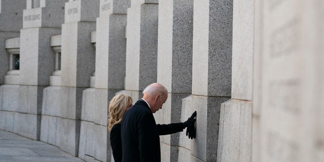President Biden and first lady Jill Biden visit the National World War II Memorial to mark the 80th anniversary of the Japanese attack on Pearl Harbor, Tuesday, Dec. 7, 2021, in Washington.