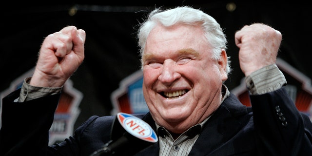 John Madden celebrates after being named into the Pro Football Hall of Fame at a news conference in Detroit, Michigan, on Feb. 4, 2006.         