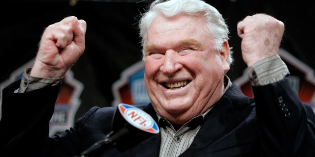 John Madden, former coach of the Oakland Raiders, celebrates after being named into the NFL Hall of Fame at a news conference in Detroit, Michigan, Feb. 4, 2006.