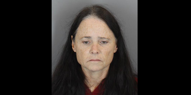 Johnna Rhone is accused of leaving the notes at the school last Friday, prosecutors say.