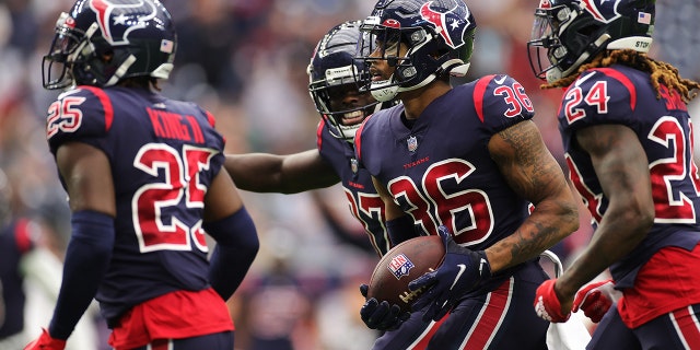 Jonathan Owens #36 of the Houston Texans celebrates his interception with teammates during the second quarter against the Los Angeles Chargers at NRG Stadium on December 26, 2021 in Houston, Texas.