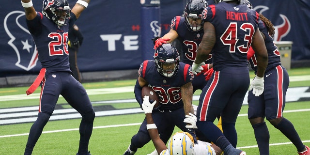 Dec 26, 2021; Houston, Texas, USA; Houston Texans defensive back Jonathan Owens (36) intercepts the ball against Los Angeles Chargers wide receiver Josh Palmer (5) in the second quarter at NRG Stadium.