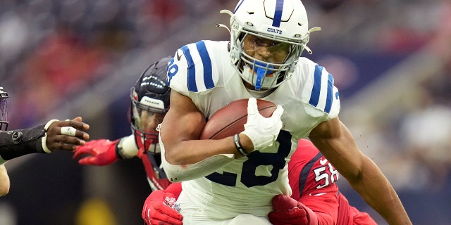 Indianapolis Colts running back Jonathan Taylor (28) is hit by Houston Texans middle linebacker Christian Kirksey (58) on a run during an NFL football game, Sunday, Dec. 5, 2021, in Houston.