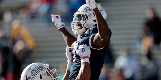 Fresno State running back Jordan Mims, reg, celebrates with teammate Juan Rodriguez (80) after scoring a touchdown against UTEP during the first half of the New Mexico Bowl NCAA college football game Saturday, Des. 18, 2021, in Albuquerque, N.M.