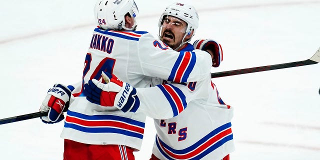 New York Rangers right wing Kaapo Kakko (24) celebrates his goal against the Arizona Coyotes with Rangers left wing Chris Kreider, right, during the third period of an NHL hockey game Wednesday, Dec. 15, 2021, in Glendale, Ariz. The Rangers won 3-2.