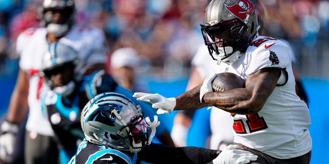 Tampa Bay Buccaneers running back Ke'Shawn Vaughn runs for a touchdown past Carolina Panthers free safety Juston Burris during the first half Sunday, Dec. 26, 2021, in Charlotte, N.C.