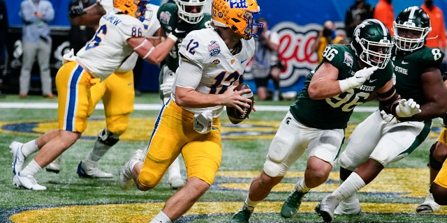 Pittsburgh quarterback Nick Patti (12) scrambles in the end zone against Michigan State during the first half of the Peach Bowl NCAA college football game, Thursday, Dec. 30, 2021, in Atlanta.