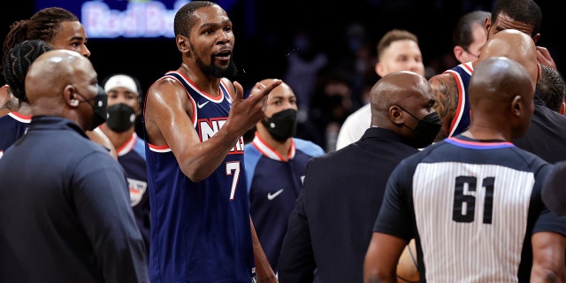 Brooklyn Nets forward Kevin Durant (7) gestures towards Philadelphia 76ers center Joel Embiid after an NBA basketball game Thursday, Dec. 30, 2021, in New York. 76ers won 110-102.