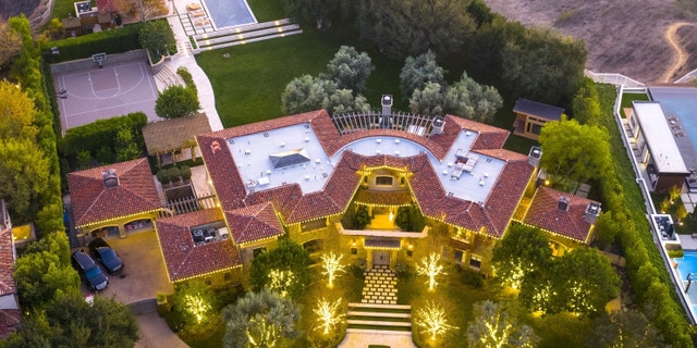 Kourtney Kardashian's Calabasas home decorated in warm white lights for Christmas.