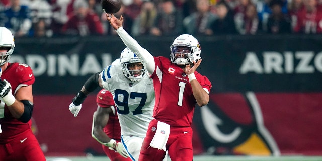 Arizona Cardinals quarterback Kyler Murray (1) throws as Indianapolis Colts defensive end Al-Quadin Muhammad (97) pursues during the second half Dec. 25, 2021, in Glendale, Ariz.