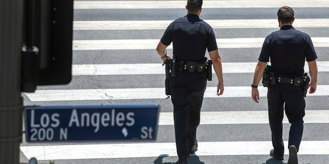 Members of the LAPD make their way along Temple St. in downtown Los Angeles.