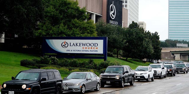 A long line of cars wait to get into the Lakewood church, which was designated as a shelter for Hurricane Harvey victims in Houston, Texas, Aug. 29, 2017.