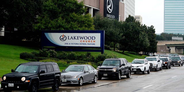 A long line of cars wait to get into the Lakewood church which was designated as a shelter for Hurricane Harvey victims in Houston, Texas August 29, 2017. REUTERS/Rick Wilking